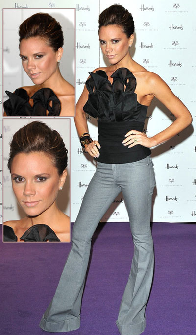 victoria beckham smiling. Here's hoping there are more bustiers in her next collection.
