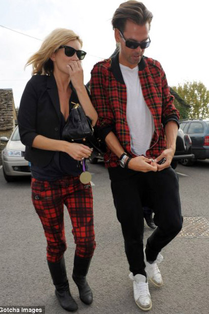 Kate Moss wearing skinny tartan pants and male friend s matching tartan jacket
